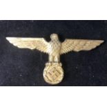 WW2 German Reich Cap Badge - a World War II original gilt finish pressed metal badge having an eagle