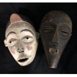 Ethnographic Native Tribal - two African carved wooden masks , one with polychrome decoration, 14