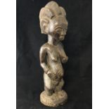 Ethnographic Native Tribal - an African carved wooden of a standing Female with protruding navel