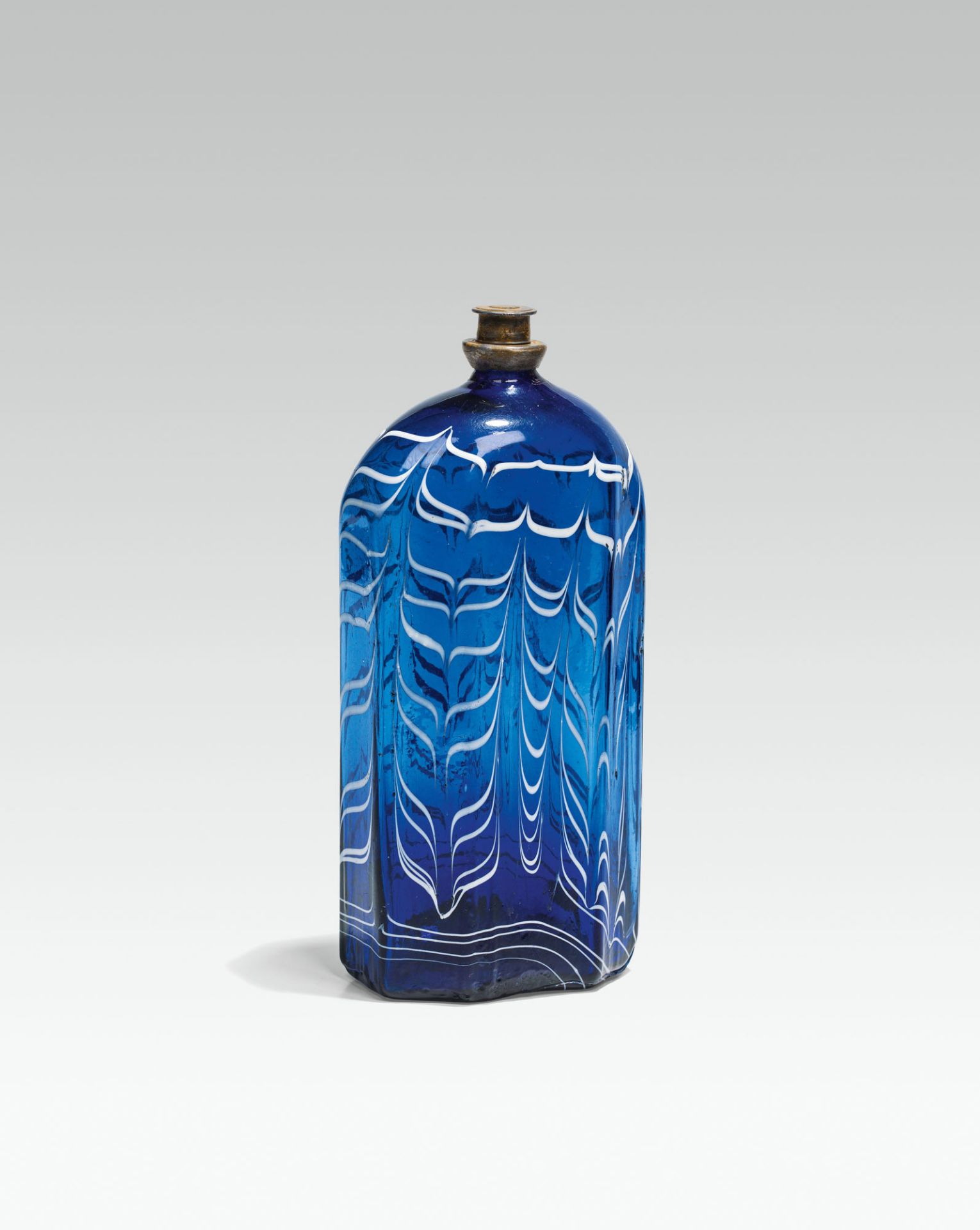 Combed bottleblue glass, combed white; pontil mark at the base; octogonal shape, rounded shoulder;