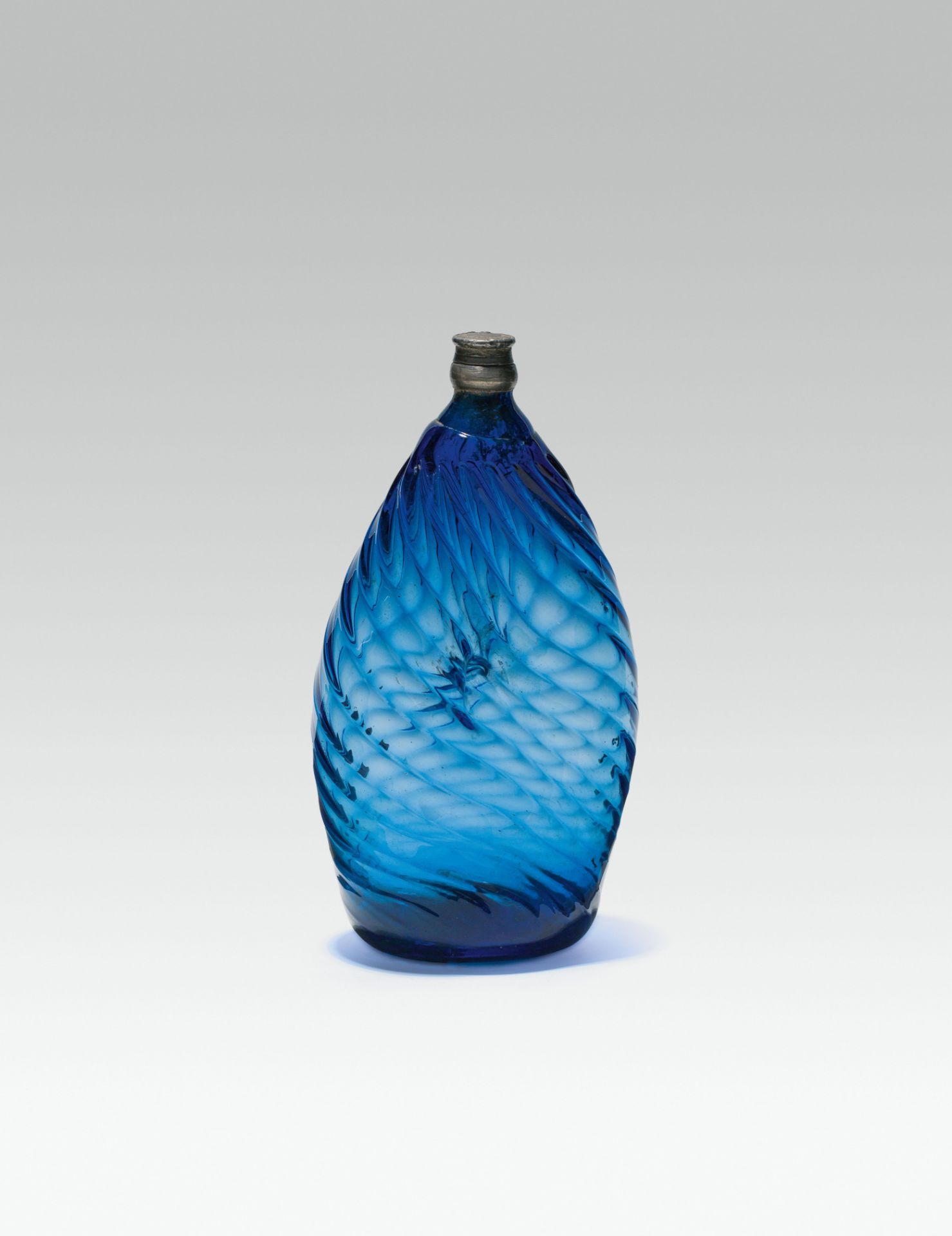Blue bottledark blue glass; pontil mark at the base; walling with structured honeycomb decor; pewter