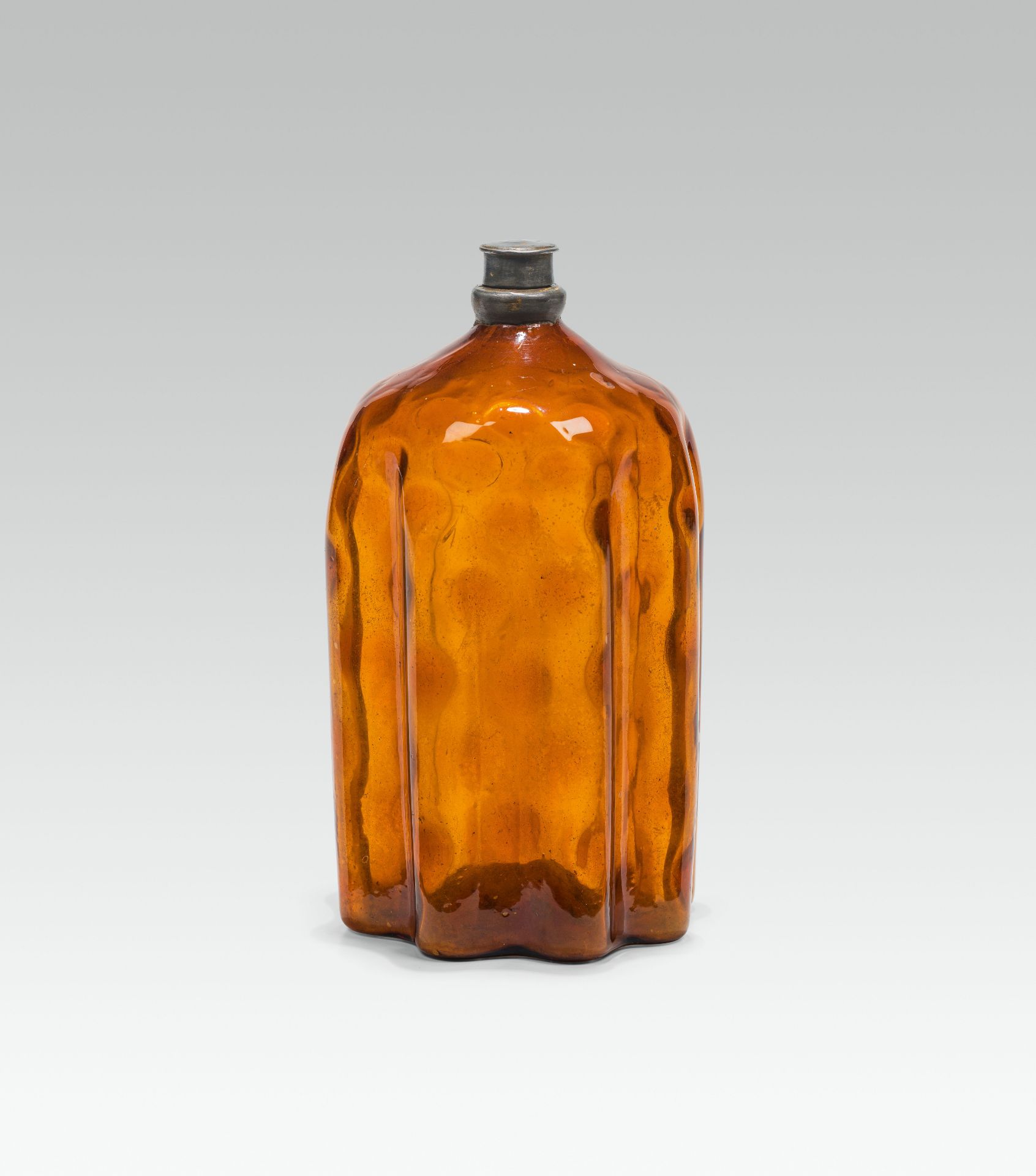 Amber bottleamber glass; pontil mark at the base; rounded shoulder; lightly structured walling