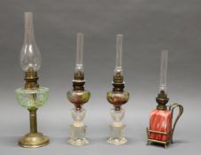 4 Petroleumlampen, 19./20. Jh., verschieden, 38.5-52 cm hoch, Altersspuren, 1x Glaszylinder schadha