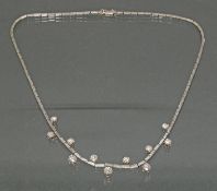 Collier, WG 750, 1 Brillant ca. 0.40 ct., 2 Brillanten zus. ca. 0.95 ct., 2 Brillanten zus. ca. 0.4