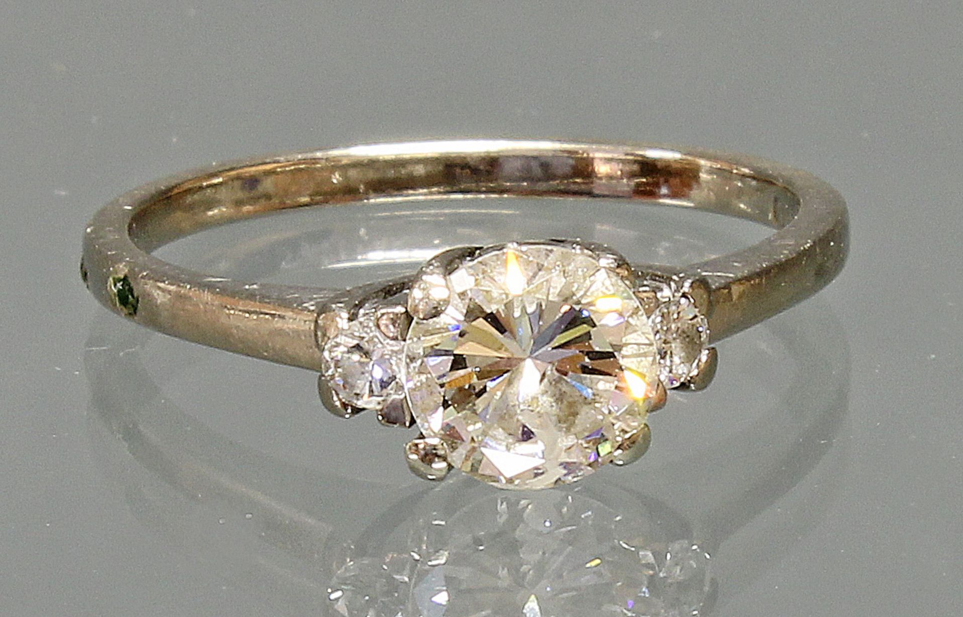 Ring, WG 750, 1 Brillant ca. 0.85 ct., etwa tcr/p1, 2 Brillanten zus. ca. 0.06 ct., etwa w/vvs, Gol