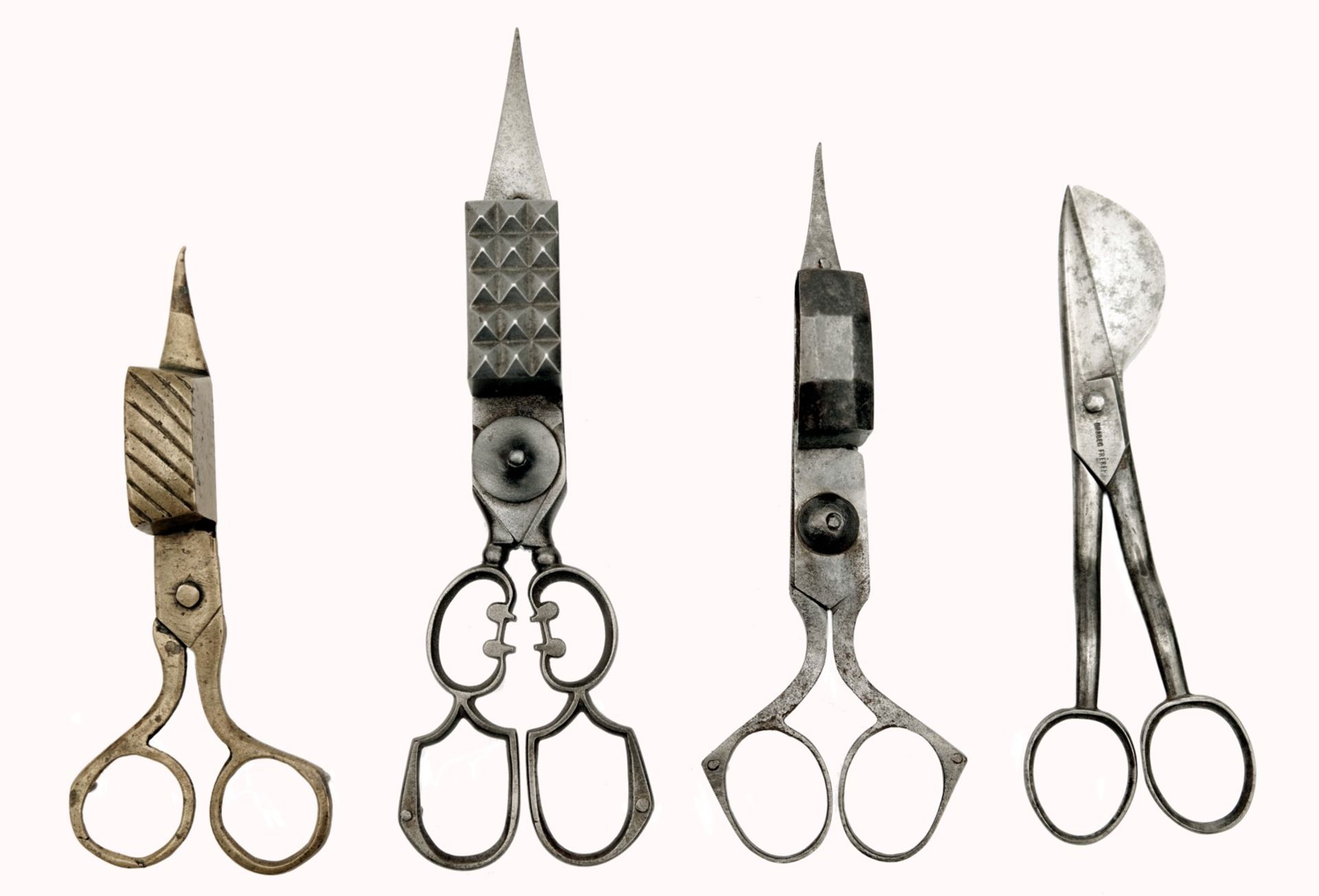 A Collection of Four Wick Trimmers