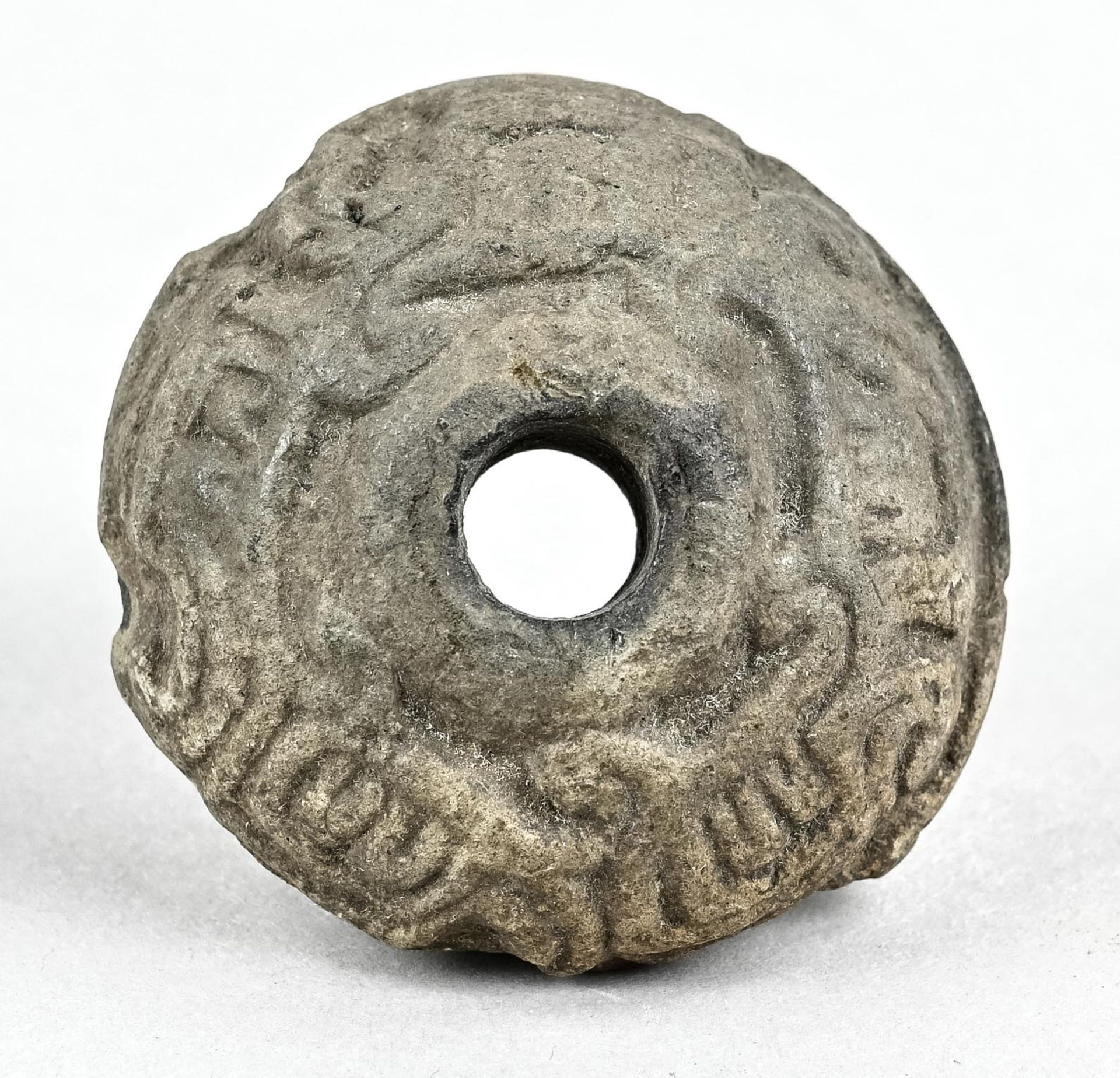 Hemispherical round millstone(?), with characters on the outside, round opening, dm 5.2 cm