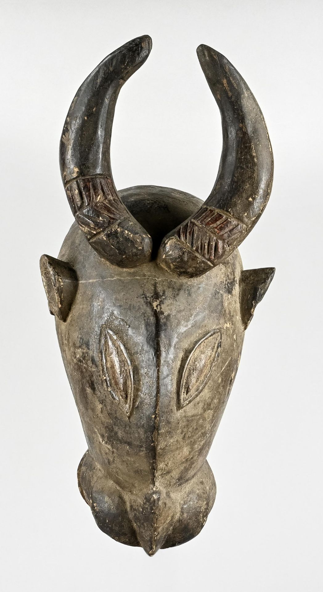 Wooden mask, African animal mask with horns and downward pointing snout with two rows of carved tee