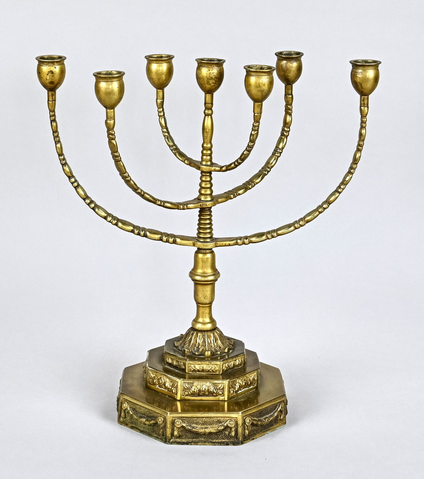 Jewish Shabbat candlestick, Germany c. 1900, brass, standing on a stepped base decorated with flora