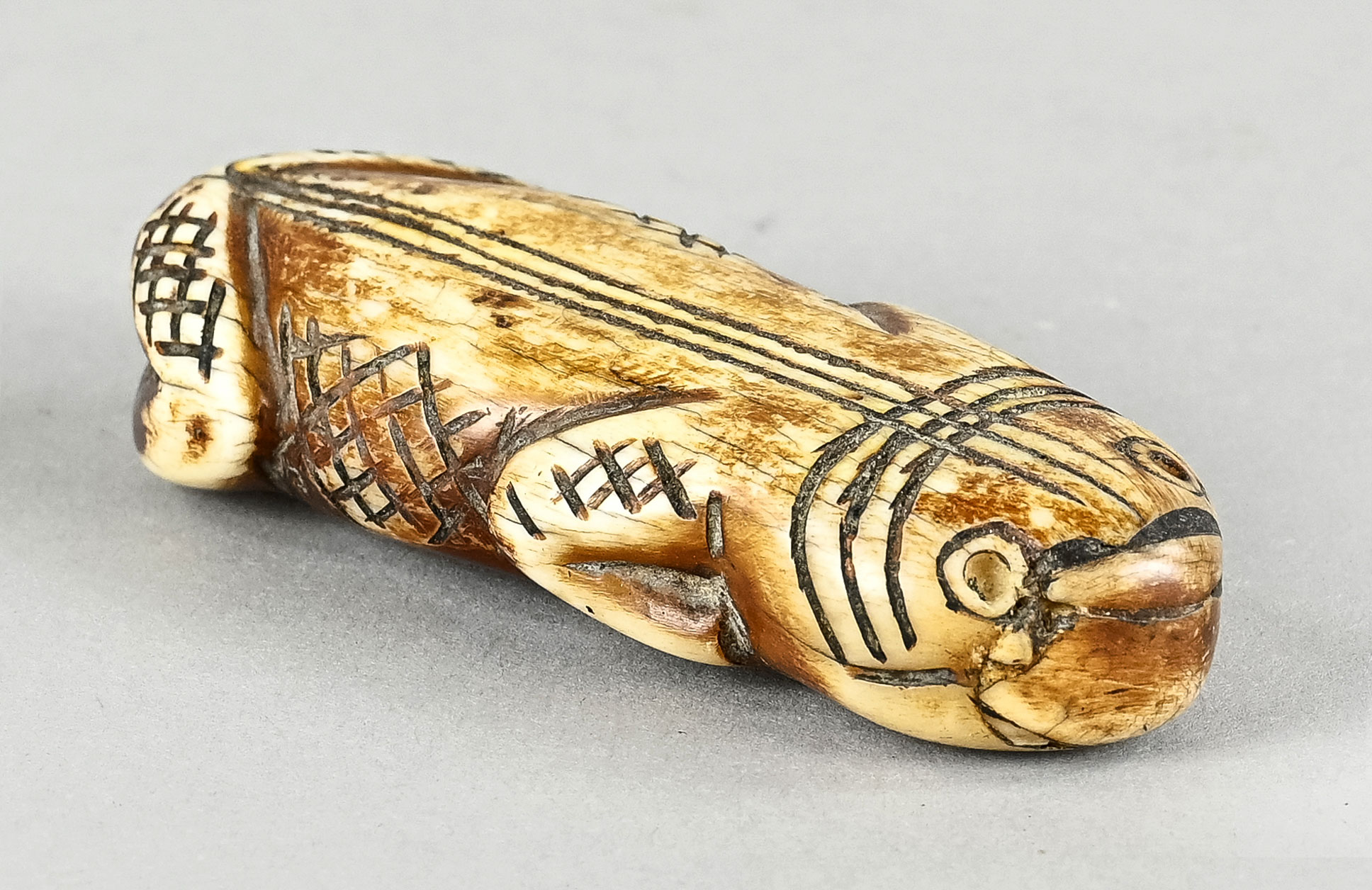 Inuit Schnitzerei, Tierfigur kauernd, mit rautenförmigen Verzierungen, aus Bein geschnitzte Figur, 