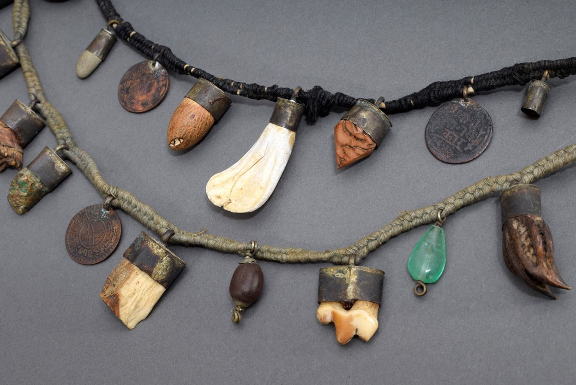 2 various Fraisen chains with different individual amulets made of bones, kernels, shells, minerals