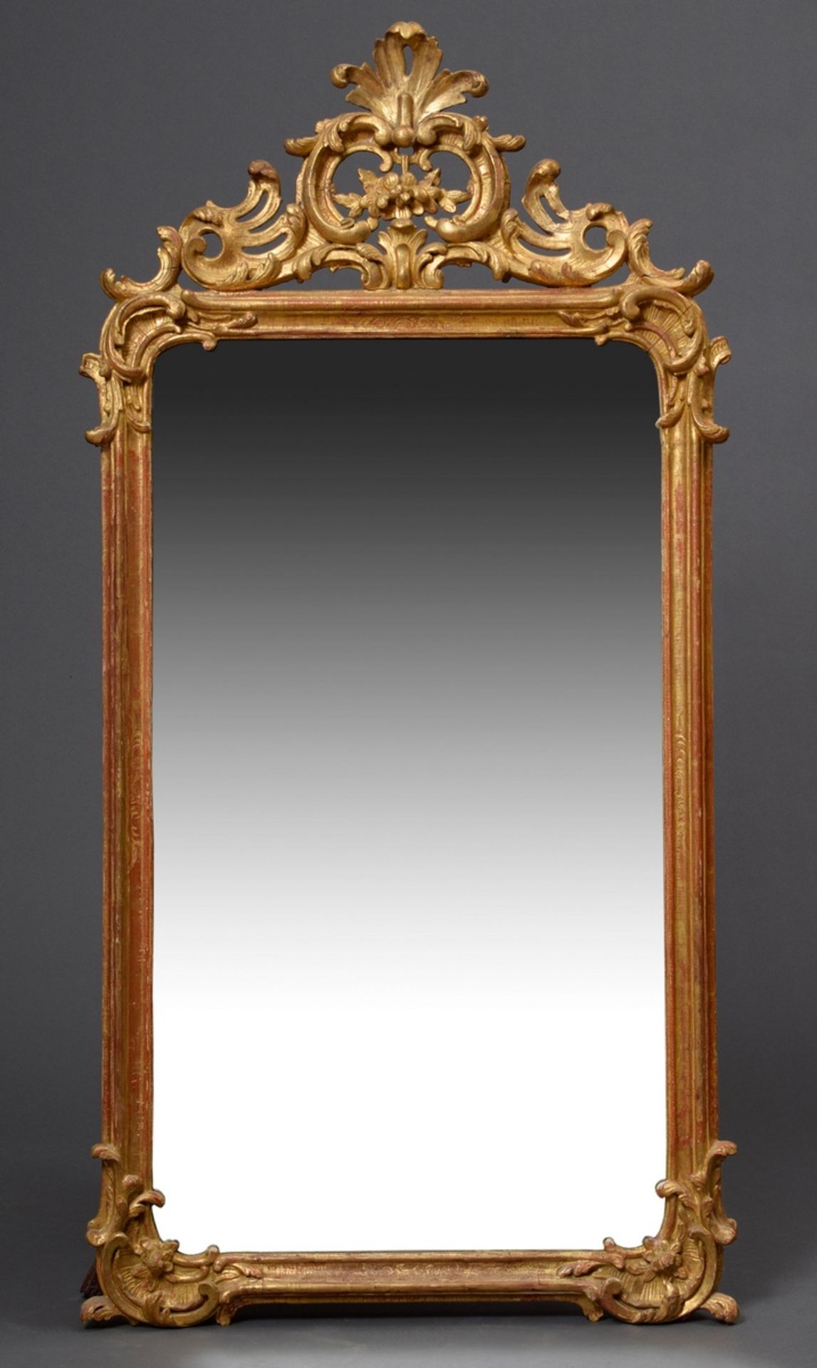 Large rococo console mirror with carved and gilded frame, openwork rocaille and floral carving in t