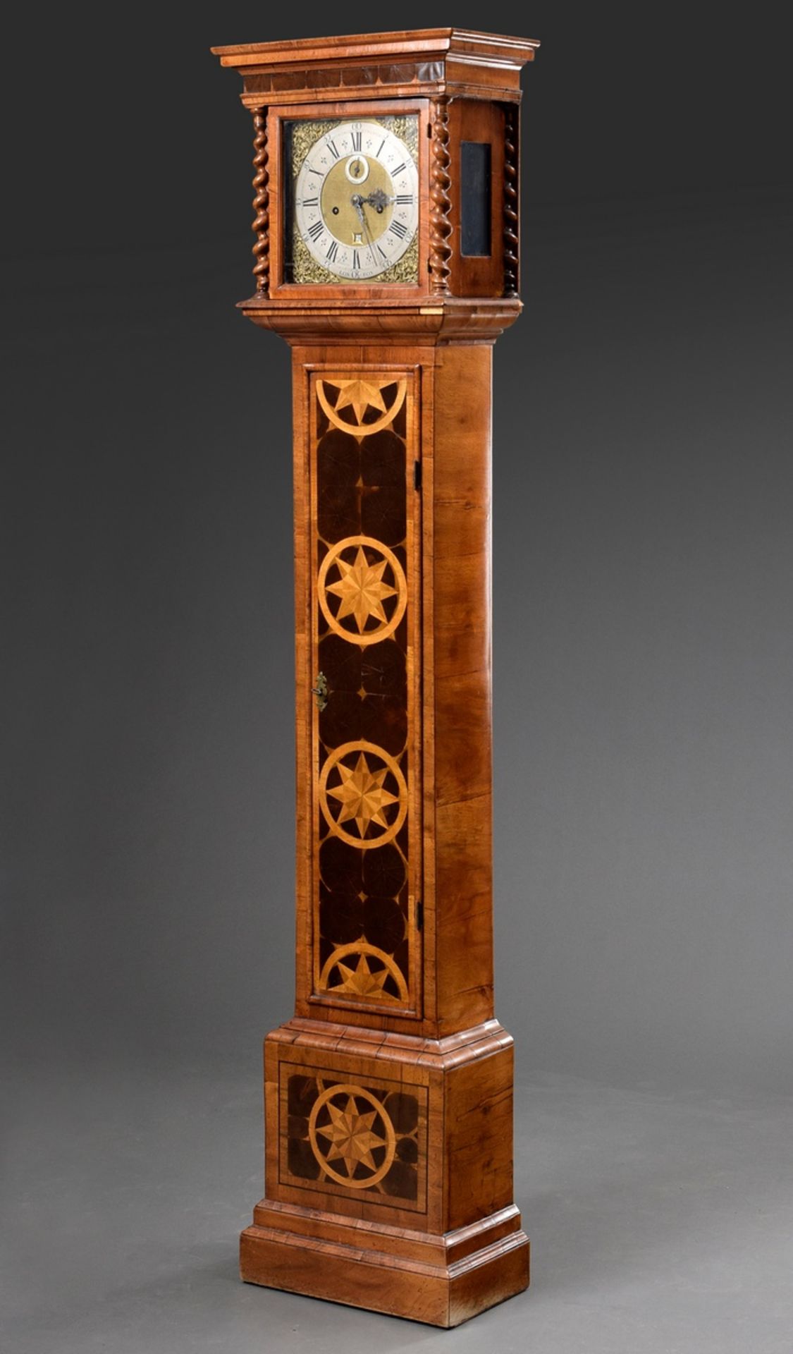 English Grandmother's Clock in veneered wooden case with turned columns on the sides, star inlays a