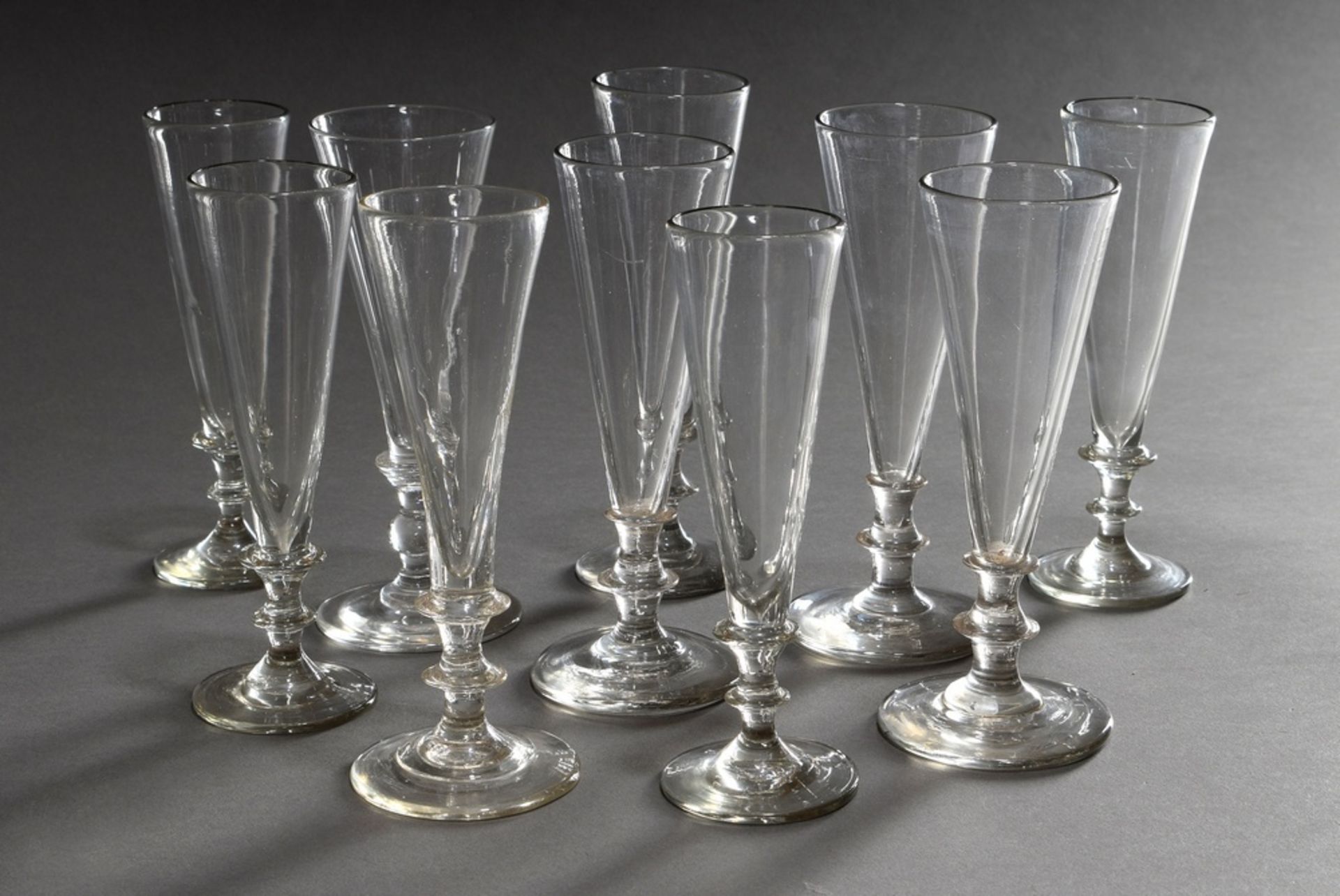 10 Plain champagne flutes with conical dome and pressed nodus in stem, 19th century, h. 17-18cm, 1x