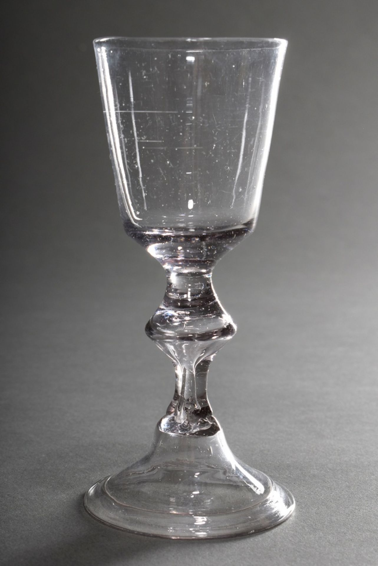 Small baroque goblet glass with hollow blown baluster stem on bell base with folded rim, 18th centu