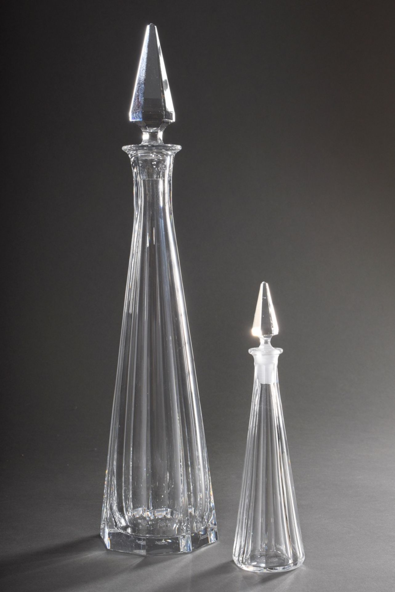 2 Various Baccarat conical carafes with facet cut, bottom signed, h. 43/22cm