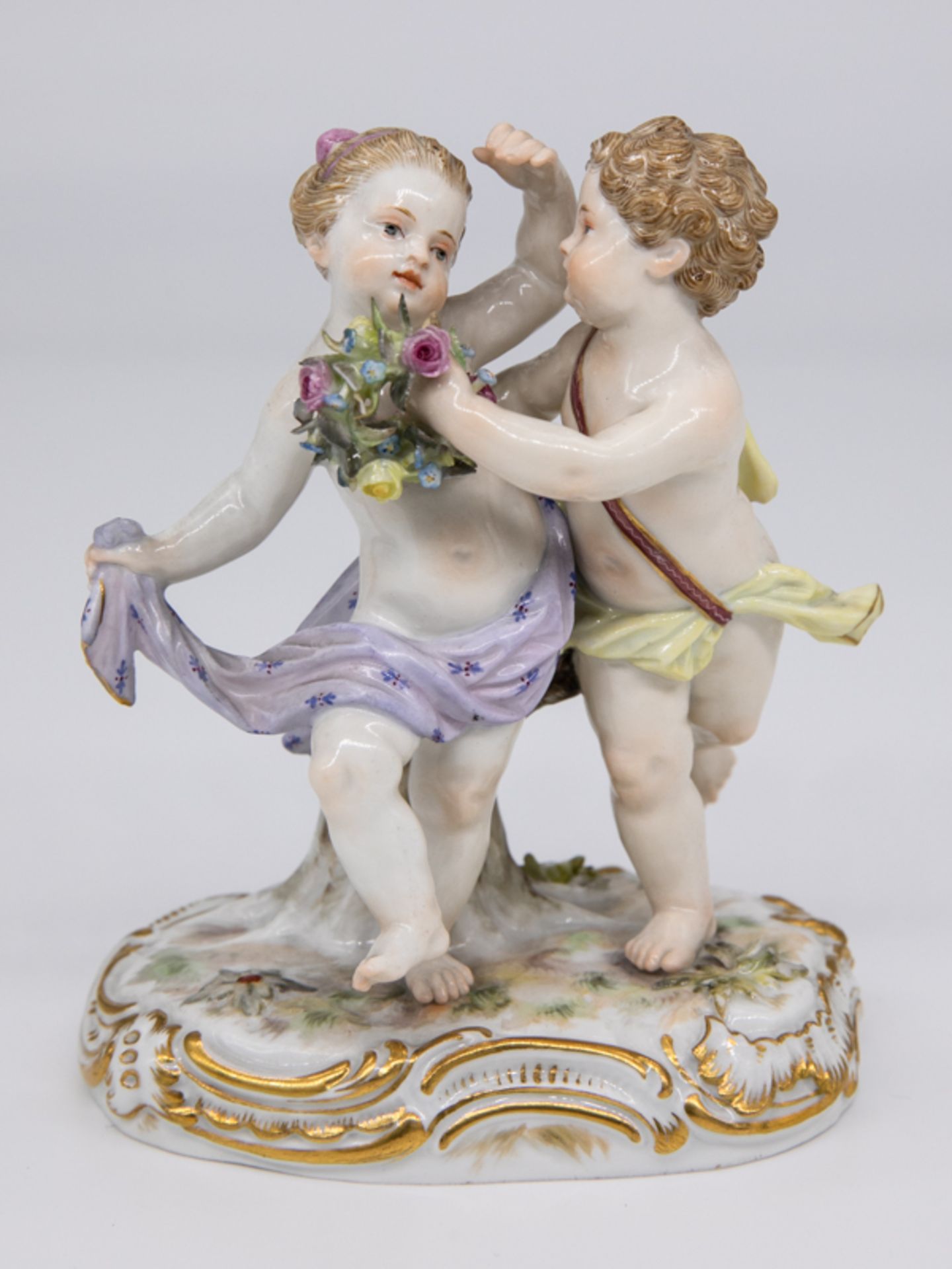 Tanzendes Puttenpaar m. Blütenkranz, Meissen, Ende 19. Jh. Weißporzellan mit polychromer Bema