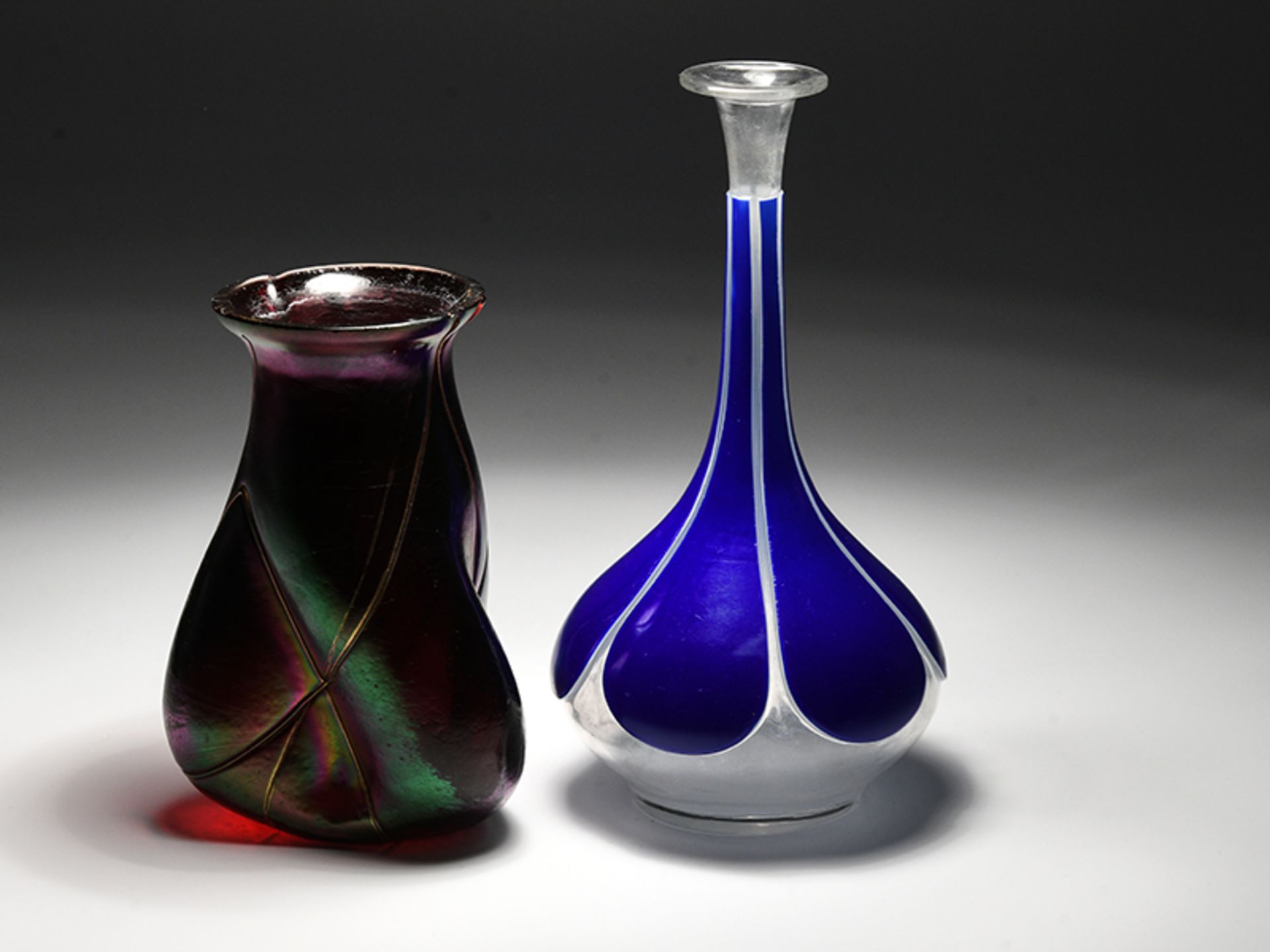 2 verschiedene kleine Jugendstil-Vasen, wohl BÃ¶hmen, Anfang 20. Jh. brFarbloses Glas, einmal rot