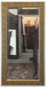 Jugendstil-Spiegel, Ende 20. Jh., Holz, gold gfaßt, floraler Reliefdekor, facettiertesGlas, 104x54