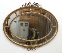 Spiegel im Louis-Seize-Stil, um 1900, Holz/Stuck, vergoldet, querovale Form, facettiertes Spiegelgl