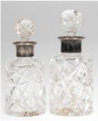 2 Karaffen, Kristall mit Schliff und 800er Silbermontierung, H. 14 und 15 cm