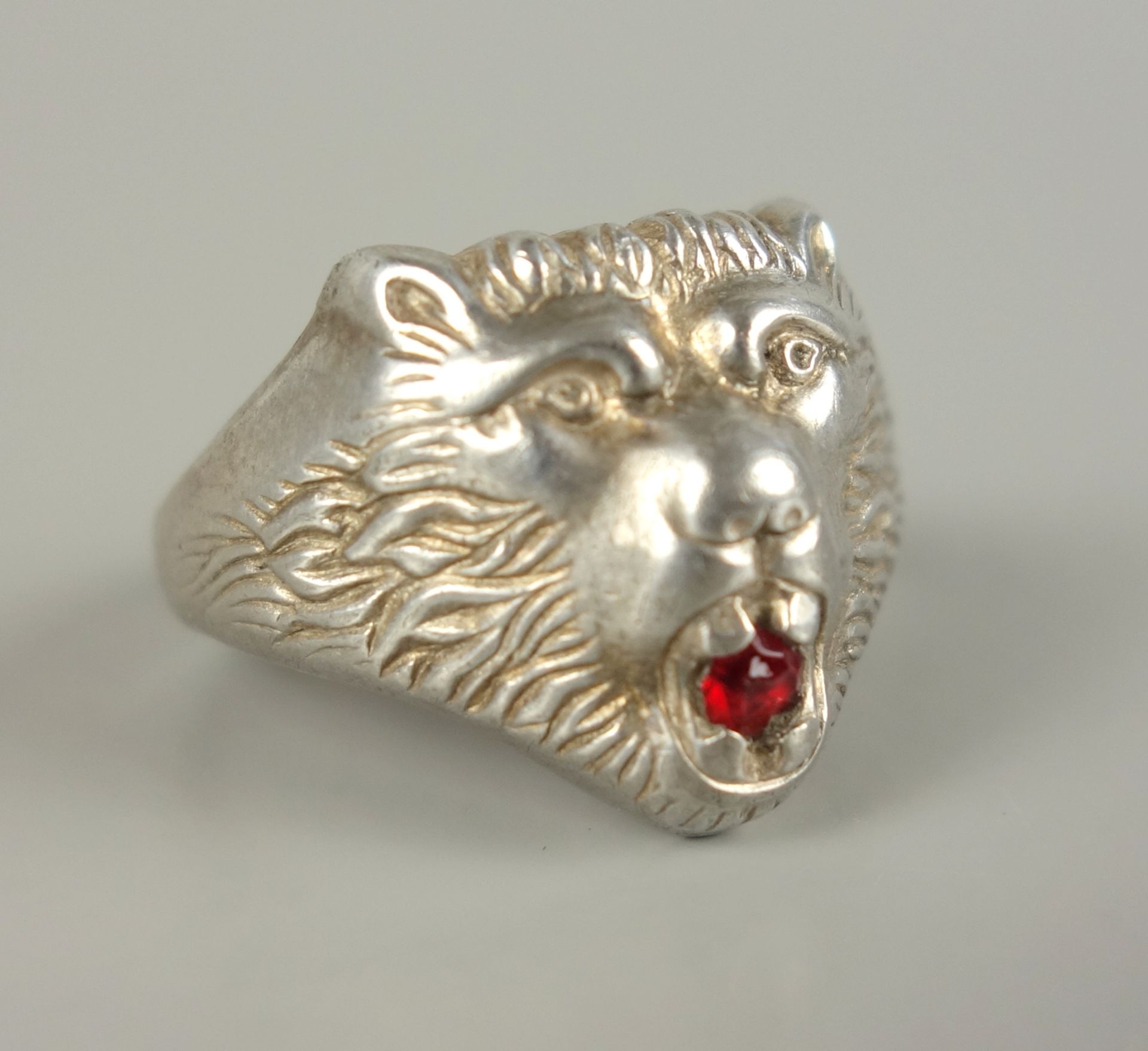 Löwenkopf-Herrenring, 835er SilberGew.6,45g, im Maul ein kleiner, rubinroter Stein, U.61 - Bild 2 aus 2