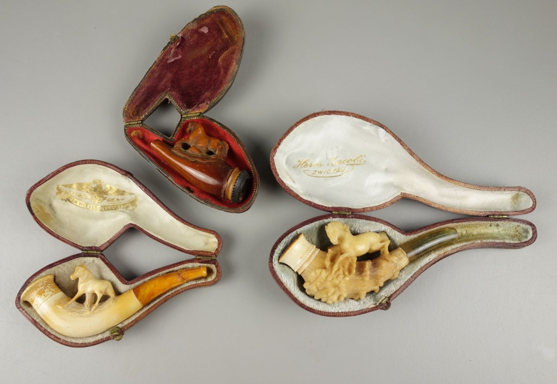 3 pipes with horse motifs, a.o. meerschaum, original cases, around 1880