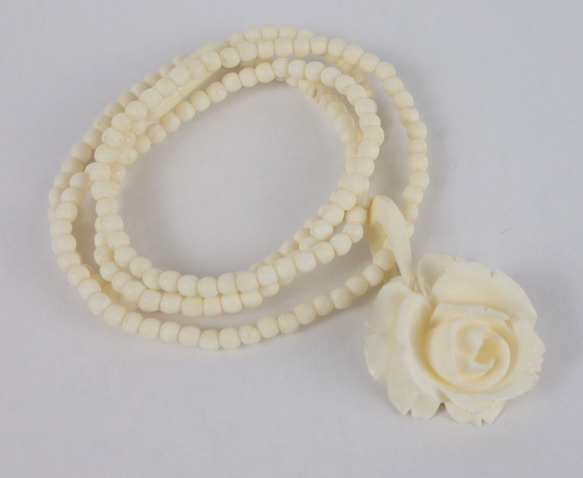 Bone ball chain with rose blossom pendant