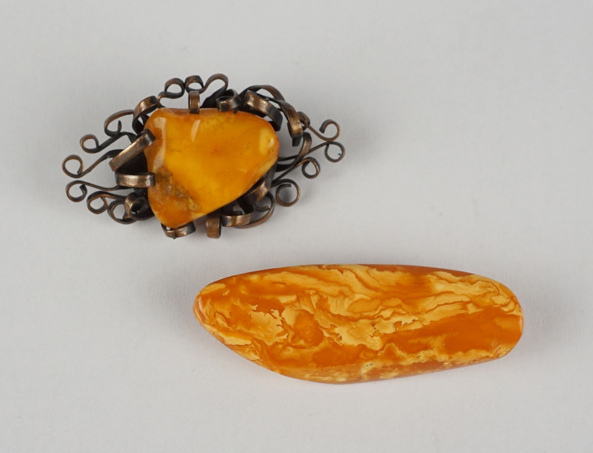 2 amber brooches, total wt.15,64g