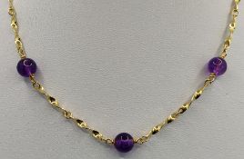 Kette mit Kugeln aus violetten Schmucksteinen, 585/14K Gelbgold, Gesamtgewicht 15,4g, Länge 57cm