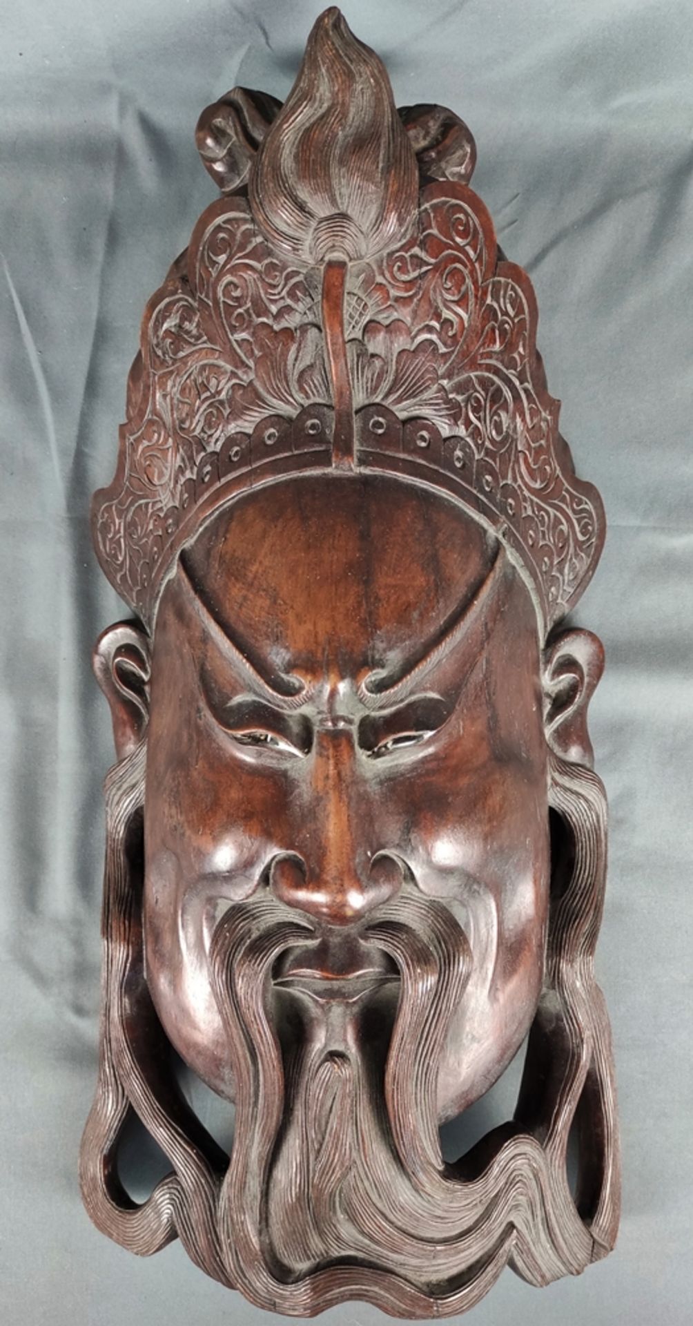 Big asian mask, face crowned with lotus flower, curved beard, eyes inserted (partly damaged), heavy
