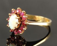 Ring, in the center a white opal surrounded by small rubies, yellow gold 585/14K, 3,9g, size 56