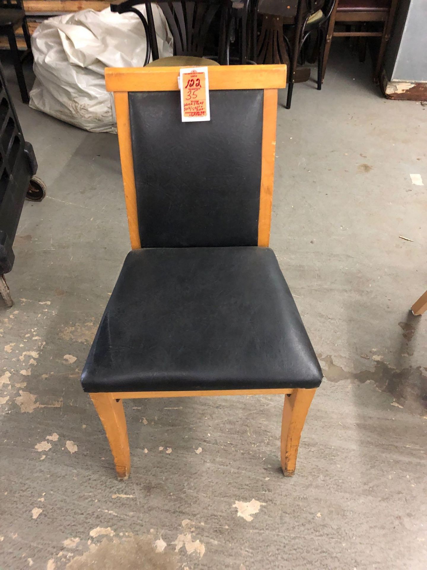 Wood chair with black padded seat and back