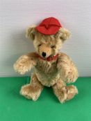 Schuco Teddy, mit roter Mütze und Halsband, H. 26 cm