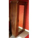 An Arts and Crafts oak single drawer wardrobe, mirrored door, copper hinges, 175cm high, 88cm