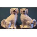 A pair of early 20th century Staffordshire dogs, picked out in gilt, c.1900