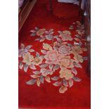 A Chinese woollen rug, with flowers, red ground, 370cm x 270mcm