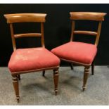 A pair of Victorian mahogany boudoir chairs, curved top rail, horizontal splat, stuffed overseat,