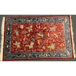 A Persian silk and wool mix rug, central panel of traditionally dressed figures on horse back