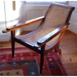 A 19th century bergere and mahogany colonial chair, tapered legs
