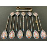 A set of eleven Russian silver gilt and cloisonne spoons, enamelled in colours, twisted hafts,