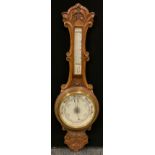An oak cased aneroid banjo barometer/thermometer, floral carved body, cream scales, 85cm high