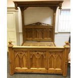 A modern Gothic pine double bed, the head and footboards carved with Gothic arches. 170cm wide x