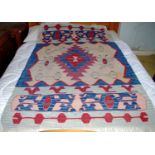 A 20th century kilim, geometrical pattern, in red, blue and white, 165cm x 115cm