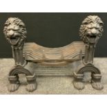 A Cast iron dog grate fire basket, Lion head terminals, arched legs, paw feet, 52cm high, 62.5cm