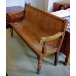 A 19th century oak settle, scroll arms , turned feet, 98cm high, 152cm wide, c.1840