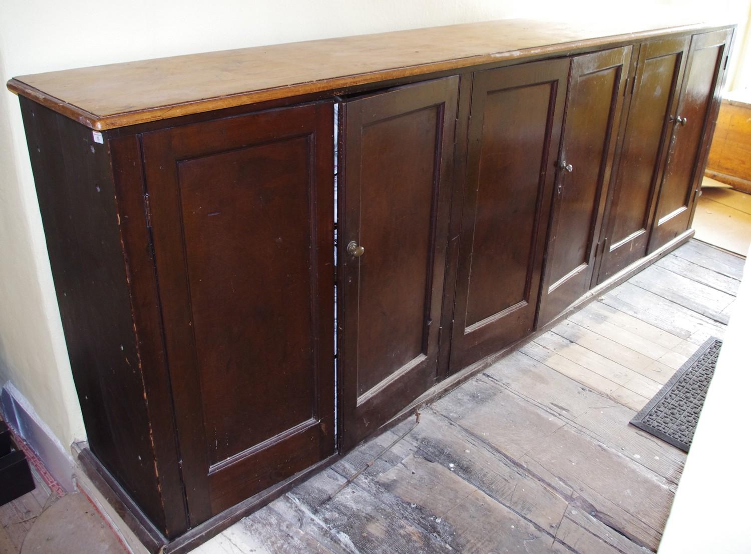A Victorian mahogany and pine six door housekeepers cabinet, fielded doors, 301cm long, 109cm