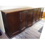A Victorian mahogany and pine six door housekeepers cabinet, fielded doors, 301cm long, 109cm