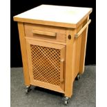 A Servus butchers block, single drawer to frieze over lattice worked door. Lockable wheels. 89.5cm