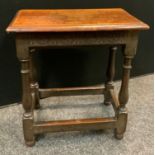An oak joint stool, moulded rectangular top, rounded carved frieze, turned and blocked legs. 56cm